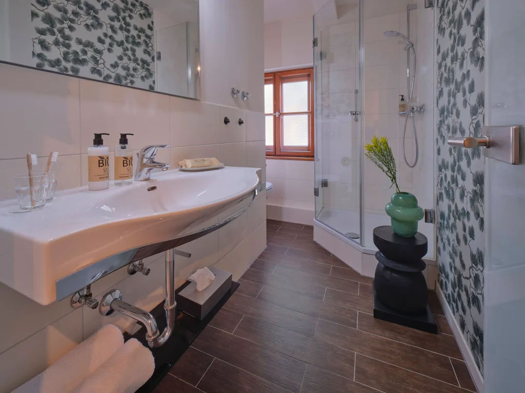 badezimmer-hell-gefließt-dunkler-laminatboden-dusche